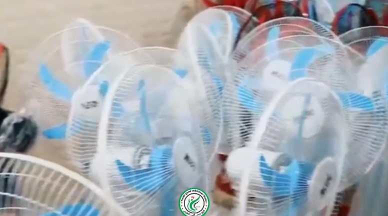 Distributing fans to widows in informal camps